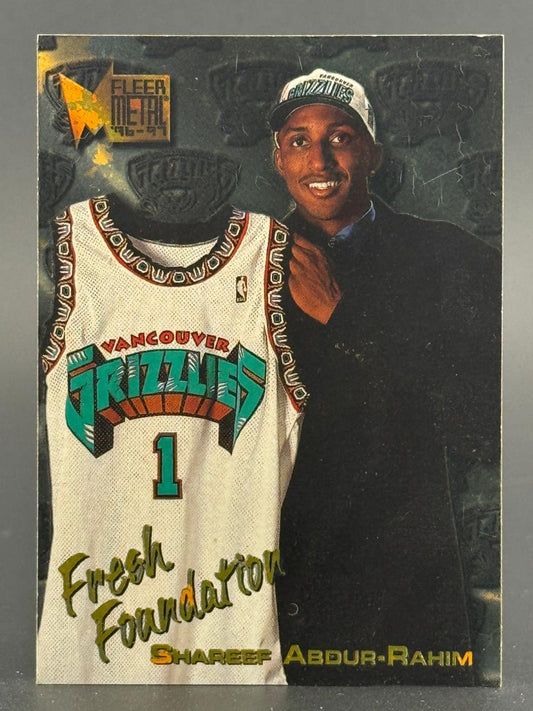 1996-97 Fleer Metal Shareef Abdur-Rahim basketball card showing him holding a Vancouver Grizzlies jersey.