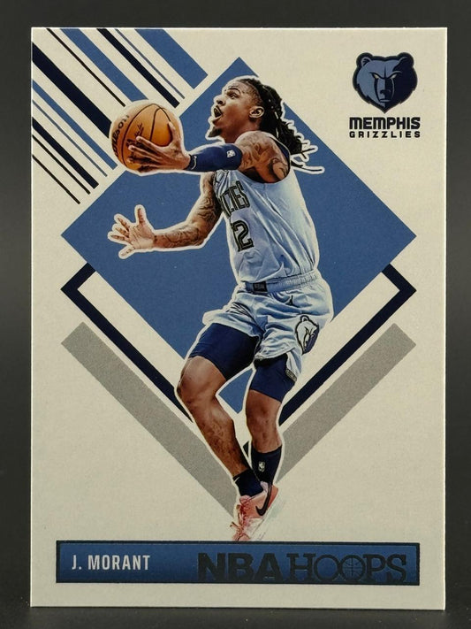 Ja Morant 2021-22 NBA Hoops basketball card, showing him in a blue Grizzlies uniform holding a basketball.
