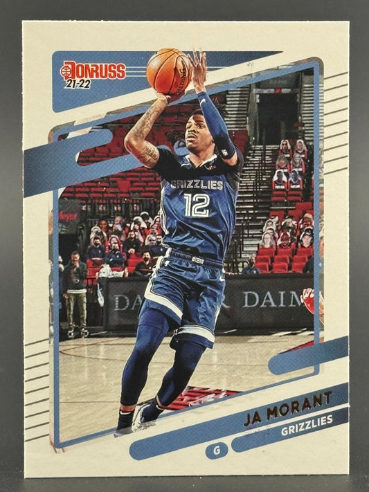 21-22 Donruss Ja Morant basketball card featuring him shooting a basketball in a Grizzlies uniform.