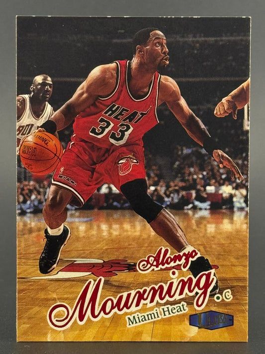 Alonzo Mourning 1996-97 Fleer Ultra basketball card dribbling in a red Miami Heat uniform.