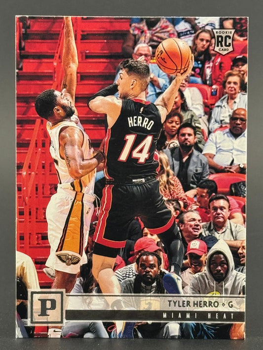 Tyler Herro 2019-20 Panini basketball rookie card showing him in a Miami Heat uniform shooting against a defender.