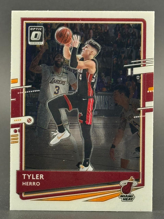 Tyler Herro Donruss Optic basketball card showing him driving to the basket with defenders.