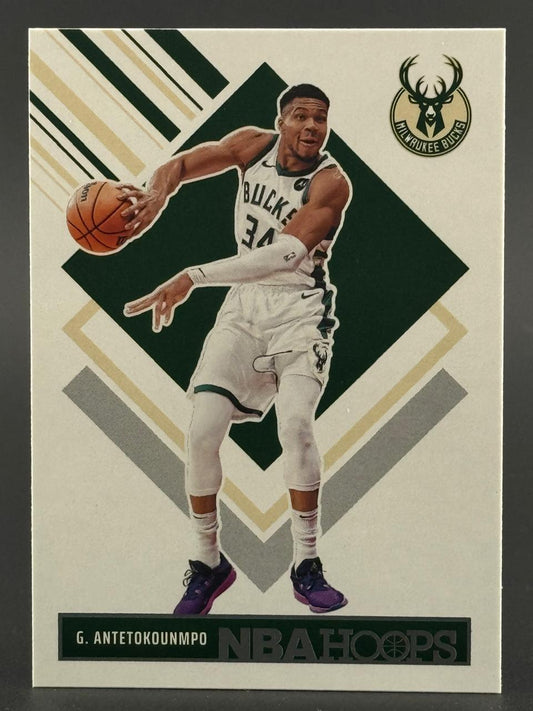 Giannis Antetokounmpo 2021-22 NBA Hoops basketball card, showing him in a Bucks uniform dribbling.