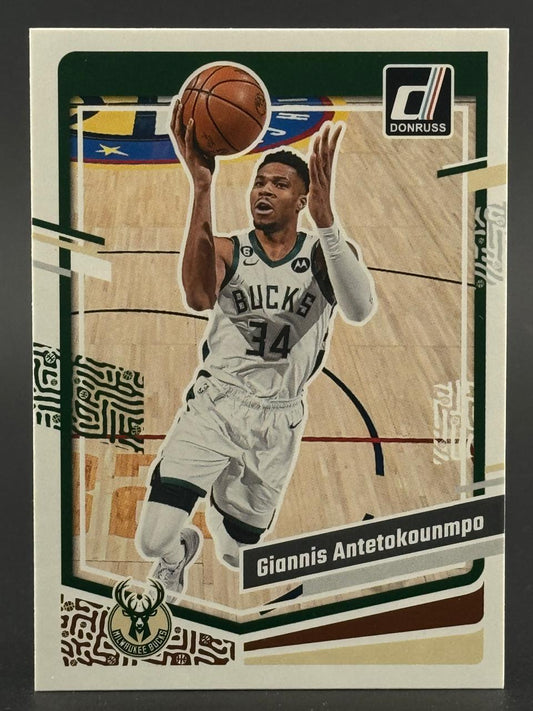 Giannis Antetokounmpo 2022-23 Donruss basketball card featuring him in a Bucks uniform shooting a basketball.