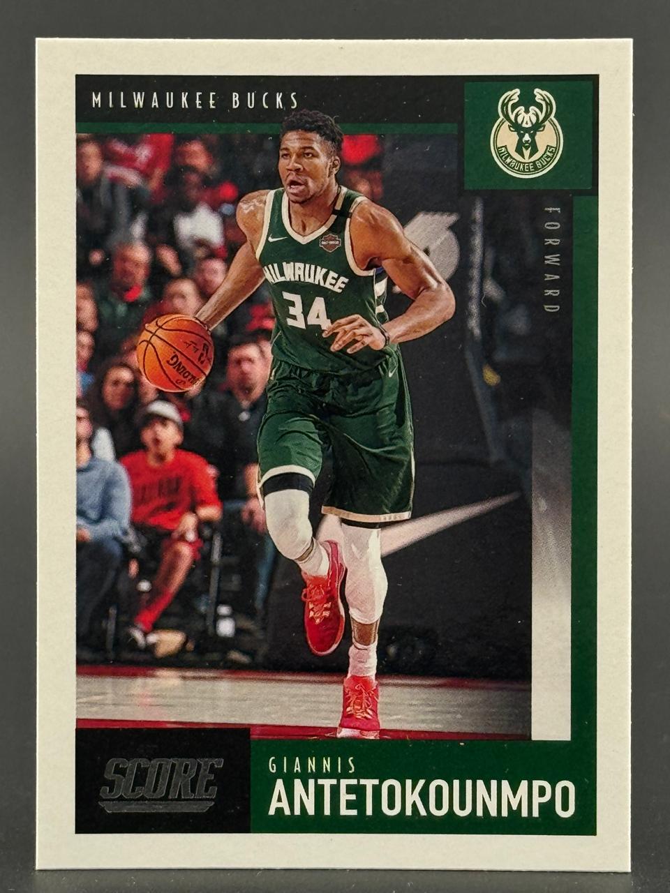 Giannis Antetokounmpo basketball trading card, Score brand, featuring him dribbling in a Bucks uniform.
