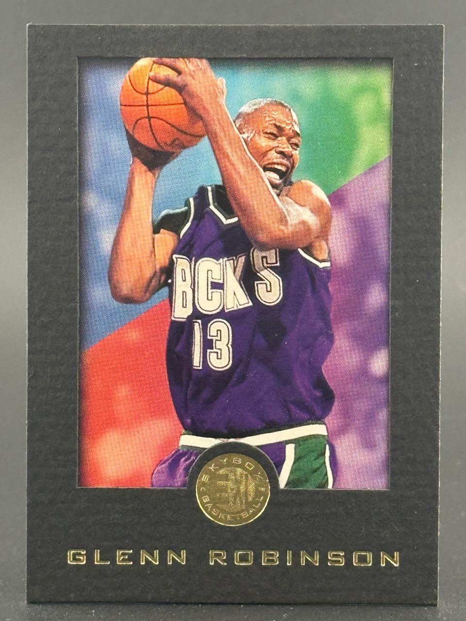 Glenn Robinson basketball trading card, showing him in a purple Bucks jersey holding a basketball.