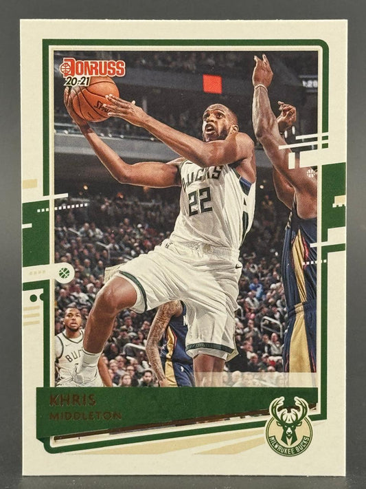 2020-21 Donruss Khris Middleton basketball card featuring him driving for a layup in a Bucks uniform.