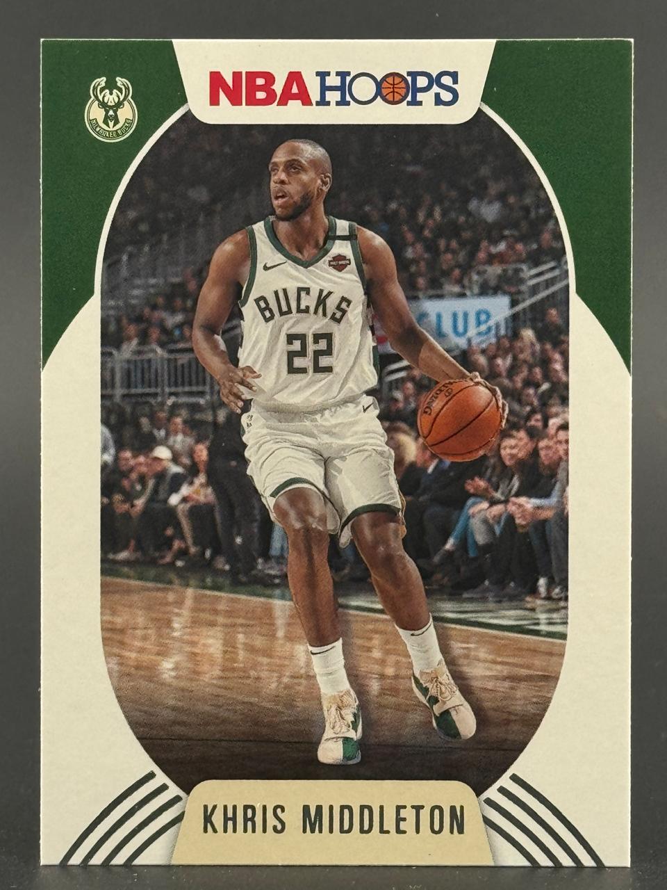 2019-20 NBA Hoops Khris Middleton #82 trading card, showing Middleton dribbling in a Bucks uniform.