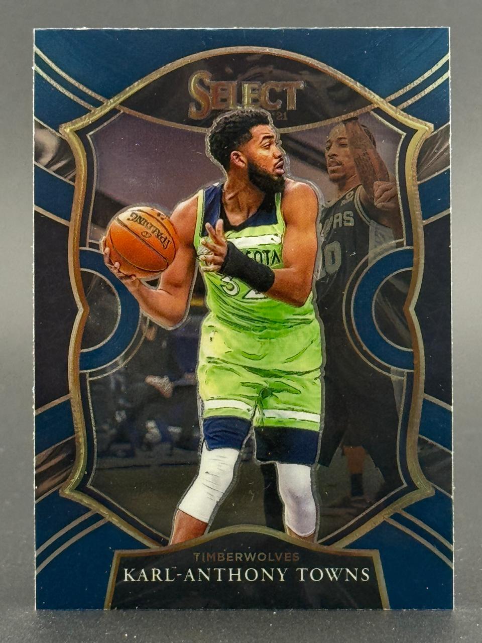 2021-22 Panini Select Karl-Anthony Towns basketball card featuring him in a neon green Timberwolves jersey.