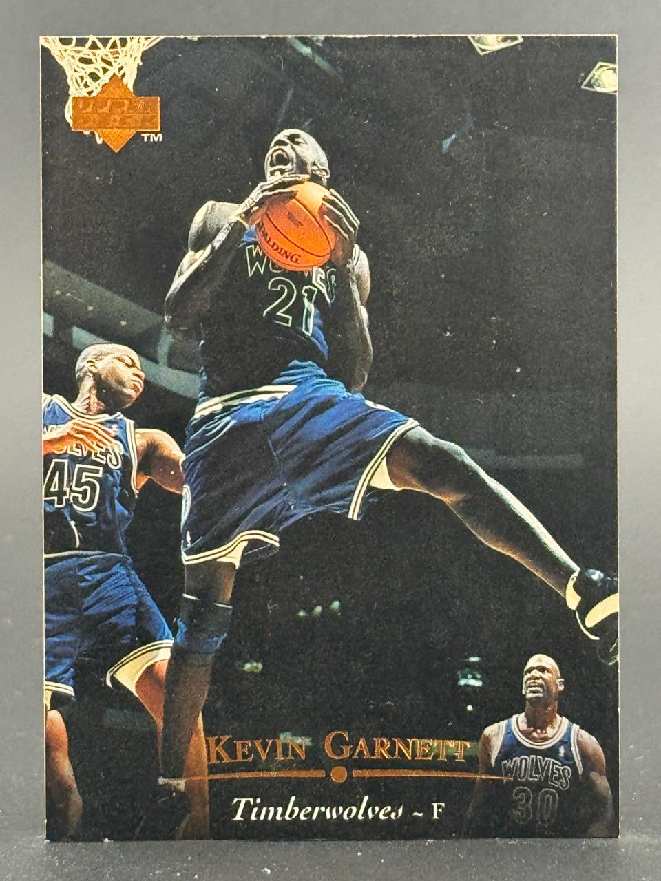 1995-96 Upper Deck Kevin Garnett #22 trading card showing him holding a basketball mid-air.