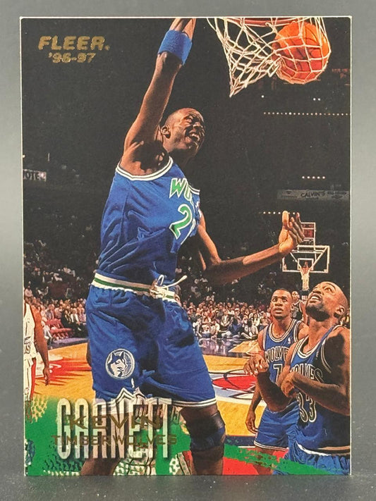 1996-97 Fleer Kevin Garnett trading card showing Garnett dunking a basketball.