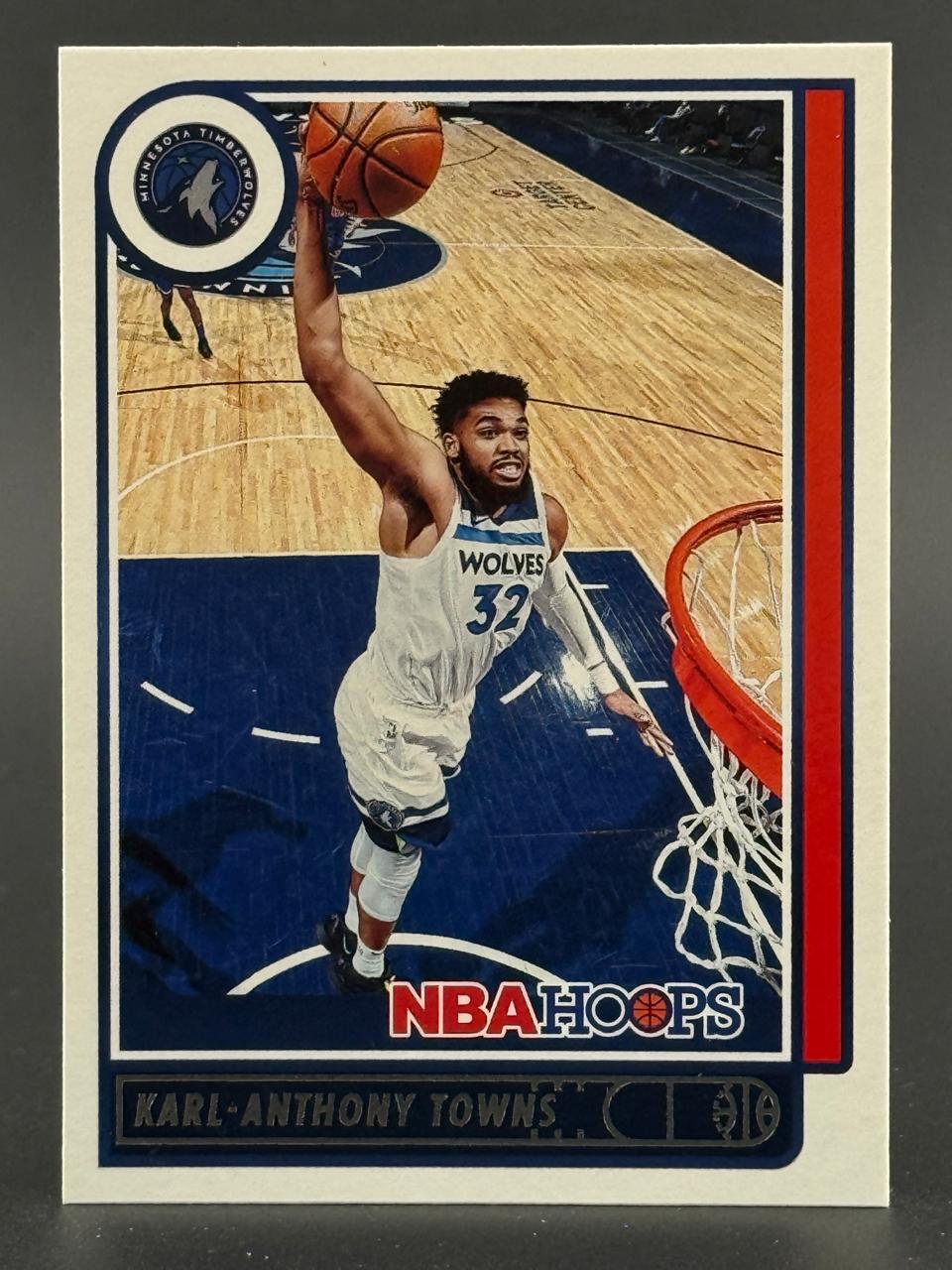 Karl-Anthony Towns on a basketball card, dunking in a white Timberwolves uniform.