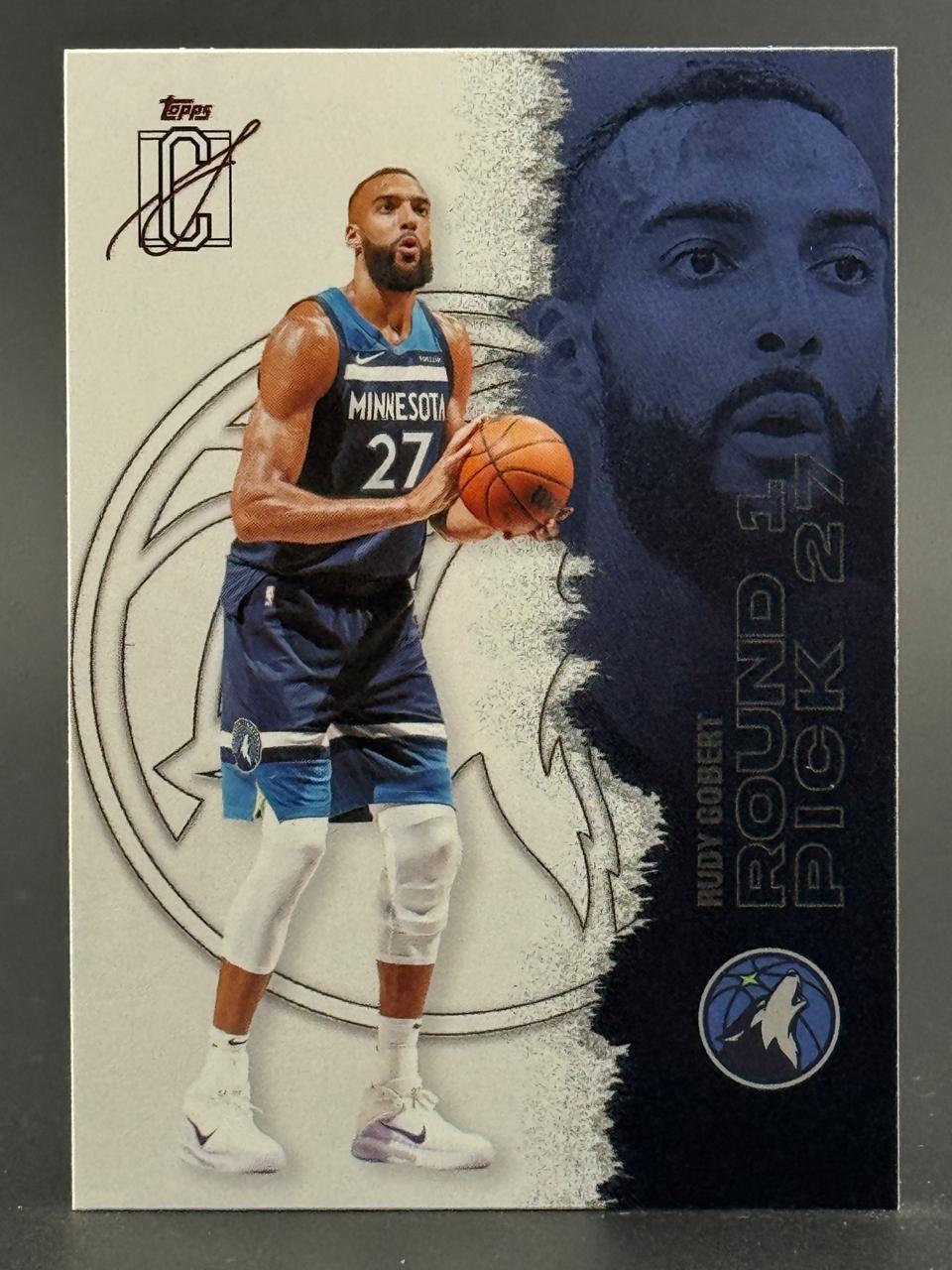 Rudy Gobert Topps basketball card, showing him in a Minnesota Timberwolves uniform holding a basketball.