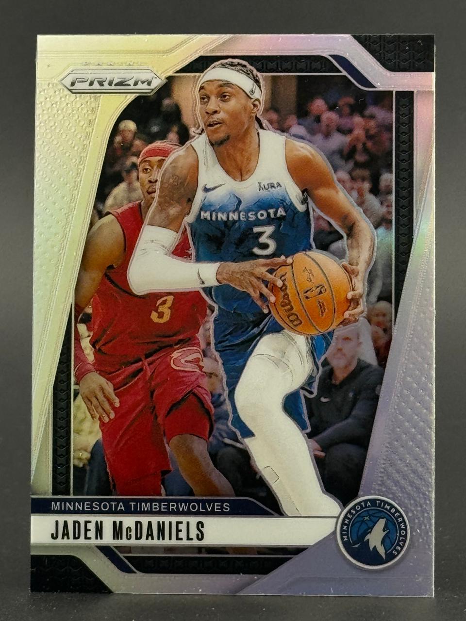 Jaden McDaniels trading card from Panini Prizm, showing him dribbling a basketball in a Timberwolves uniform.