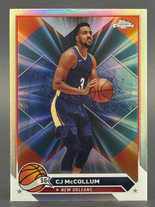 CJ McCollum Topps Chrome basketball card holding ball in New Orleans uniform.