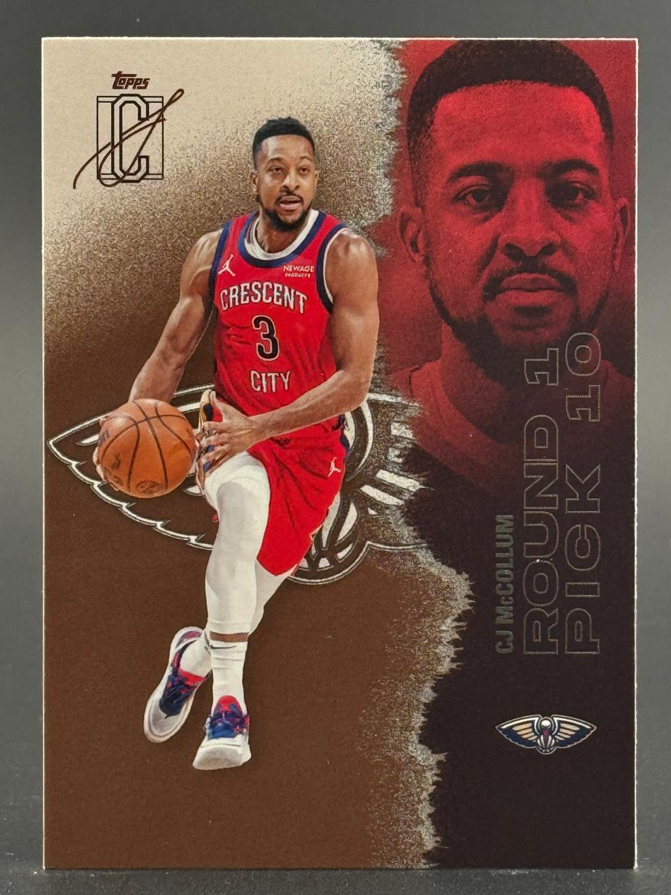 CJ McCollum Topps trading card, showing him dribbling in a red Crescent City jersey with a large portrait on the right.