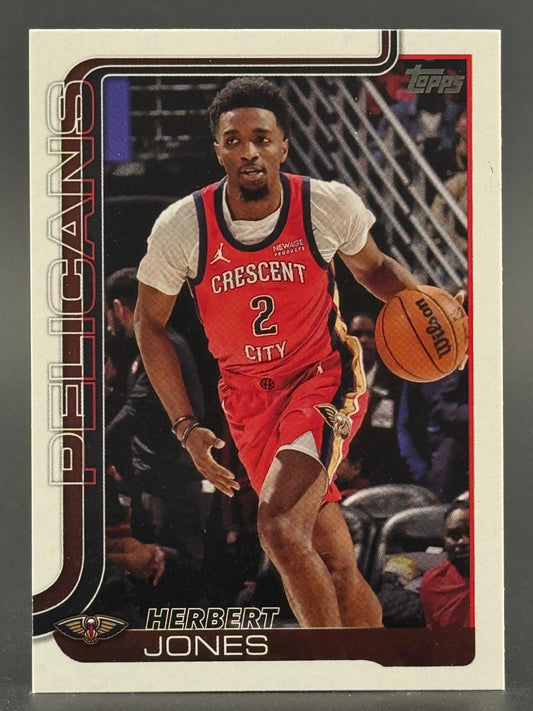 Herbert Jones Topps basketball card, depicting him dribbling in a red Pelicans jersey.