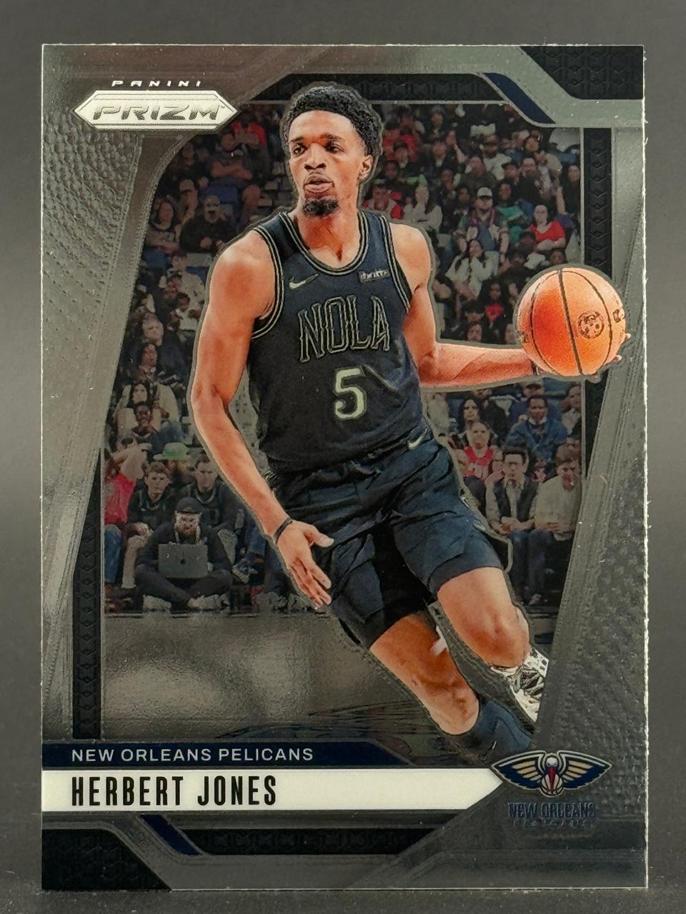 Panini Prizm trading card of Herbert Jones in a black New Orleans Pelicans uniform dribbling a basketball.