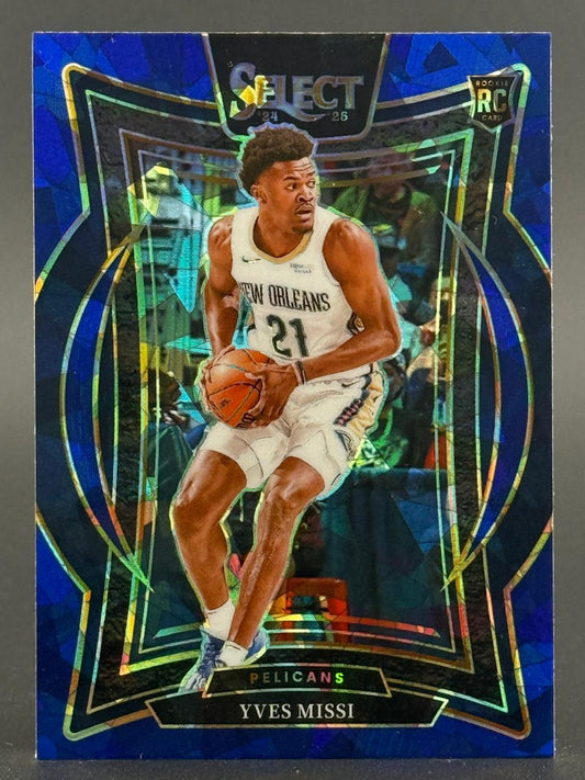 2024-25 Select Yves Missi rookie basketball card showing him holding a basketball in a Pelicans uniform.