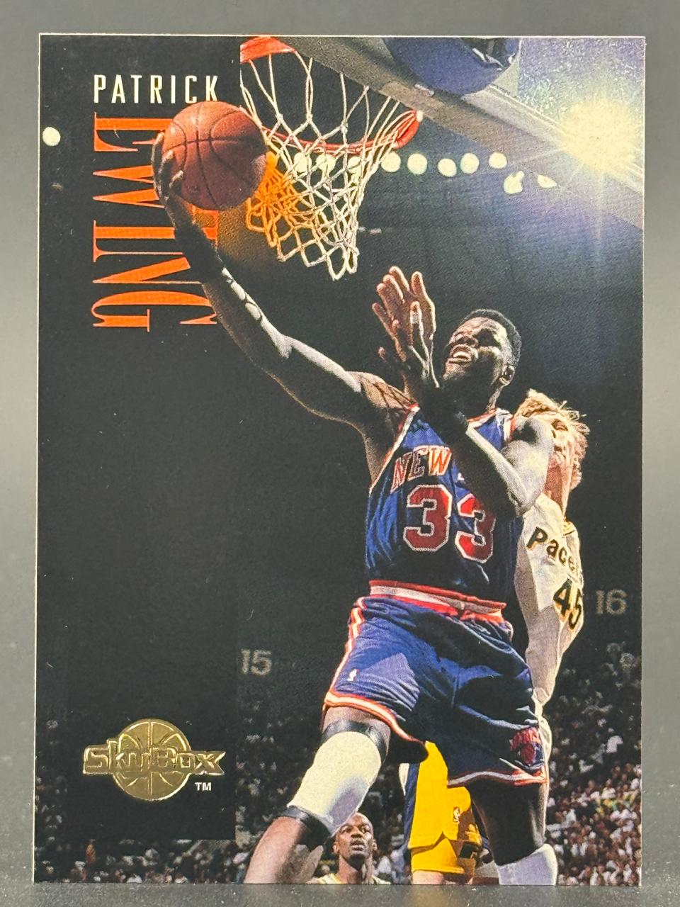 Patrick Ewing trading card, SkyBox brand, showing him in a New York Knicks uniform going up for a layup.