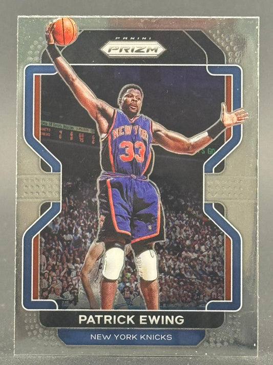Patrick Ewing 2021-22 Panini Prizm trading card showing him dunking in a New York Knicks uniform.