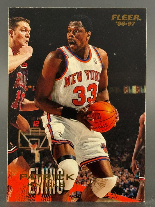 1996-97 Fleer Patrick Ewing trading card featuring the New York Knicks center holding a basketball.