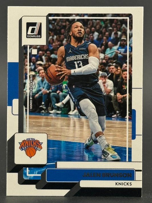 Jalen Brunson 2021-22 Donruss basketball card featuring him in a Mavericks uniform with a Knicks logo inset.
