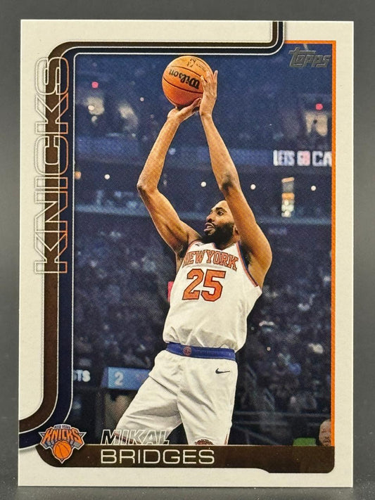 Trading card of Mikal Bridges in a New York Knicks jersey, shooting a basketball.