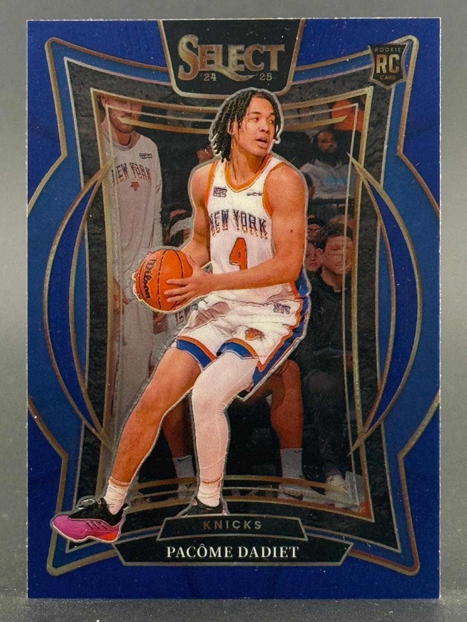 24-25 Panini Select Pacôme Dadiet rookie trading card featuring the Knicks player holding a basketball.