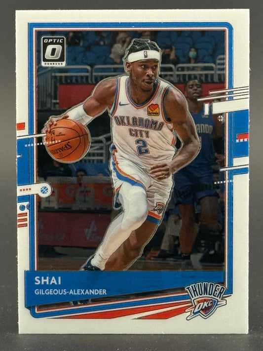 Shai Gilgeous-Alexander 2020-21 Donruss Optic basketball card dribbling in uniform.
