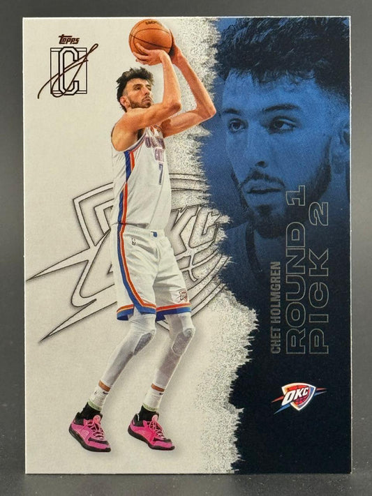 Chet Holmgren basketball trading card featuring him shooting in a white uniform, with a blue portrait.