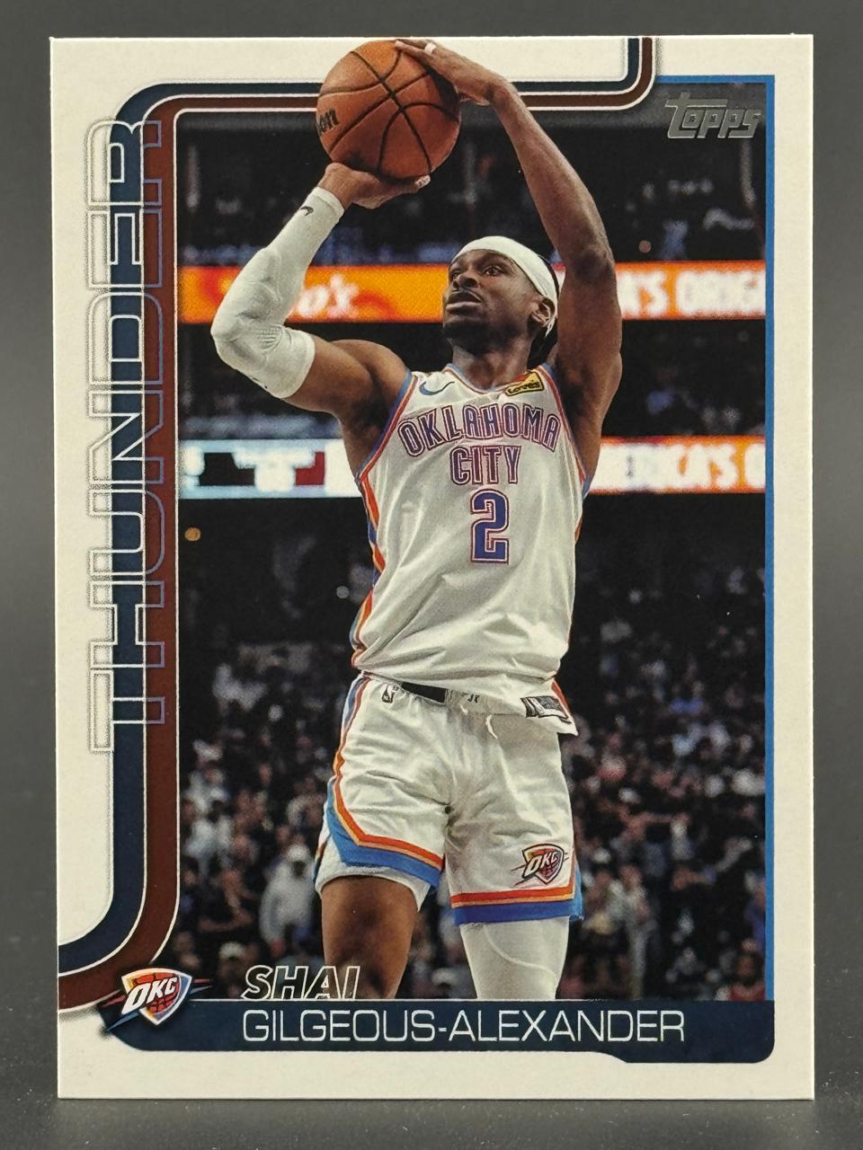 Shai Gilgeous-Alexander basketball trading card, shooting a jump shot in an OKC uniform.