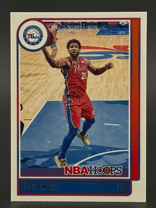 Joel Embiid 76ers basketball card, NBA Hoops set, showing him in a red uniform on the court.