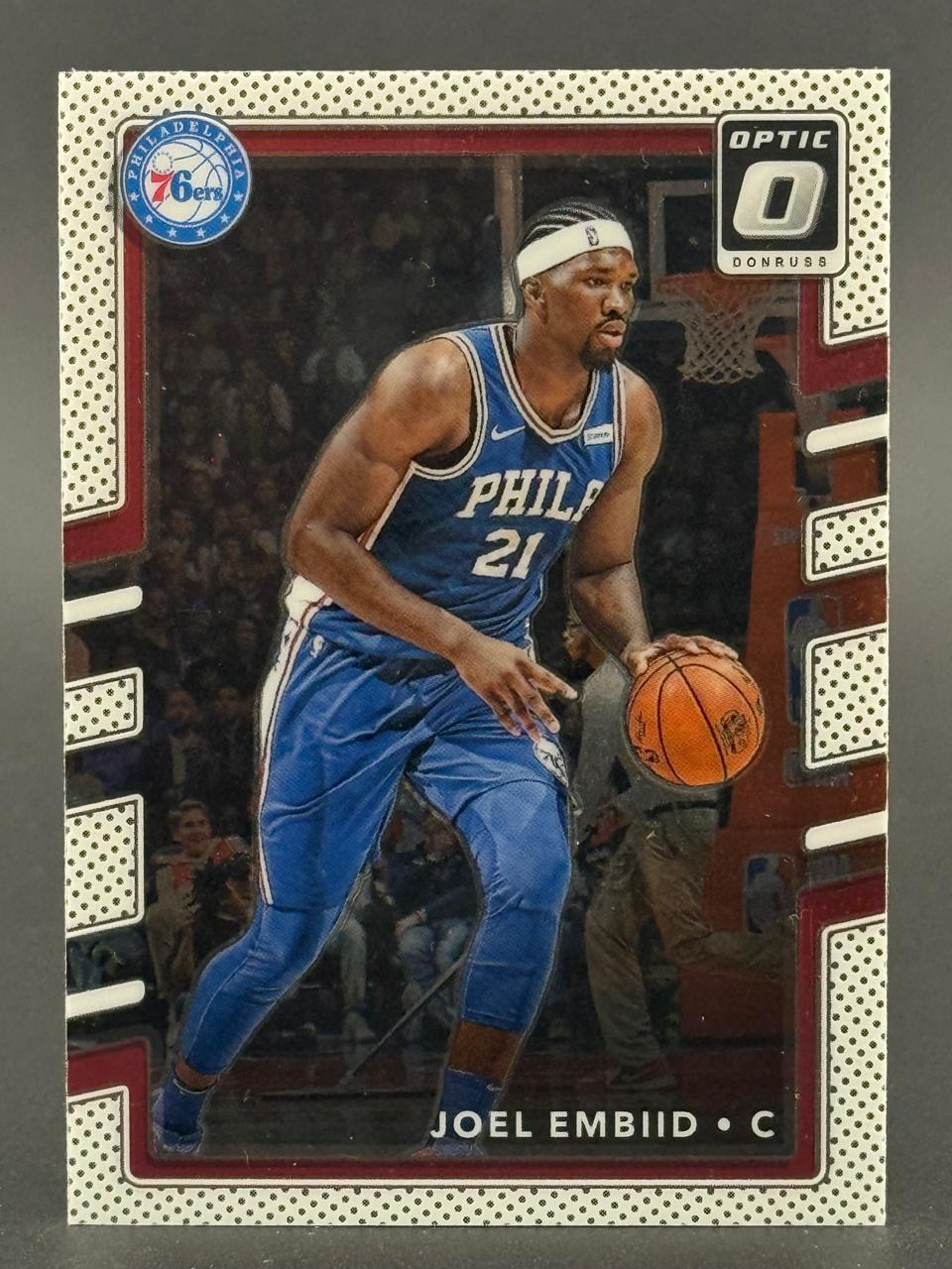Joel Embiid 76ers Optic Donruss basketball card dribbling in uniform.