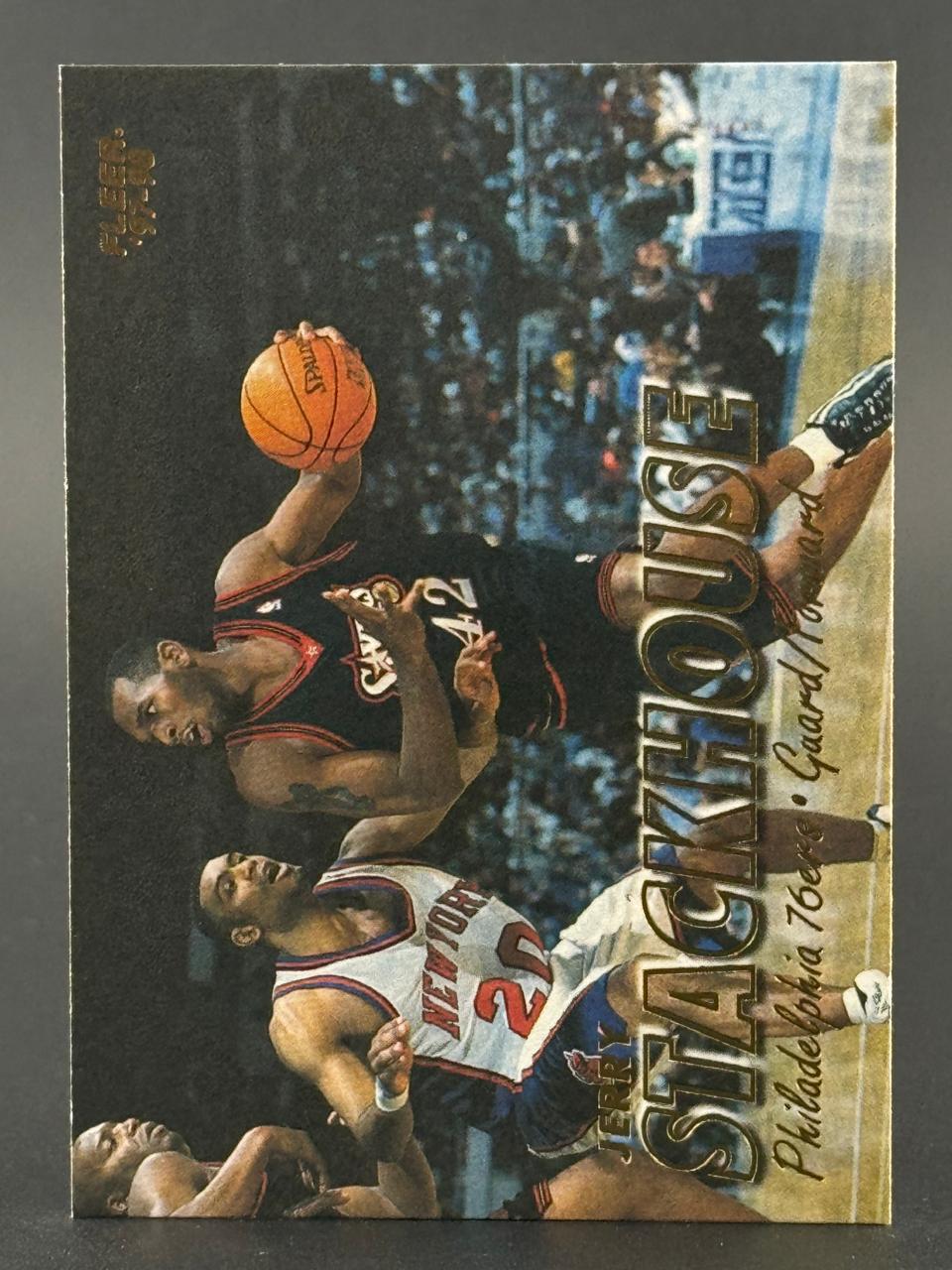 1997-98 Fleer Jerry Stackhouse basketball trading card, showing action with a defender.