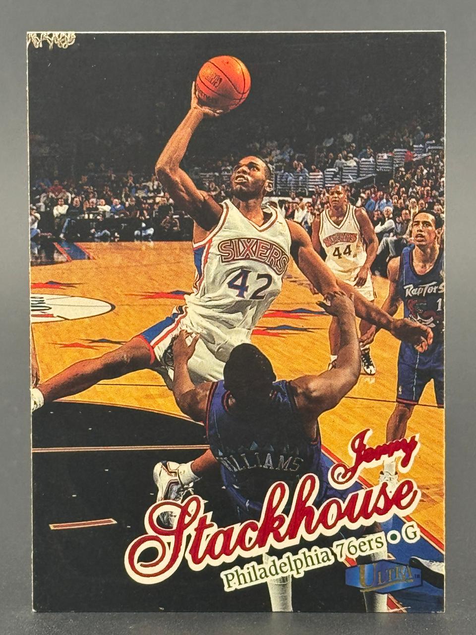 Jerry Stackhouse basketball card showing him driving to the basket in a 76ers uniform.
