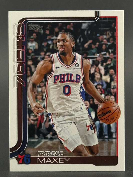 Tyrese Maxey Topps trading card showing him dribbling a basketball in a Philadelphia 76ers uniform.