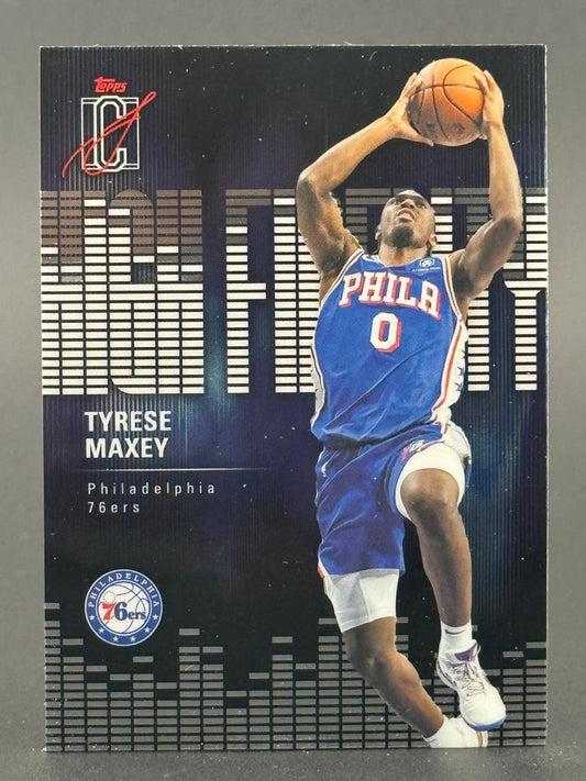 Tyrese Maxey Philadelphia 76ers basketball card, holding basketball overhead, wearing blue uniform #0.