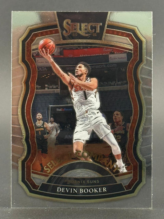 2020-21 Select Devin Booker basketball card showing him driving with a basketball.