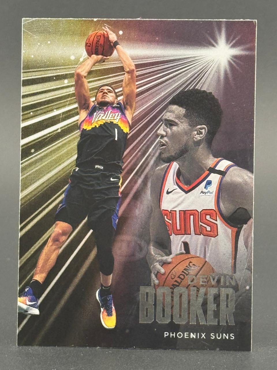 Devin Booker Phoenix Suns basketball card showing Booker shooting and in a portrait.