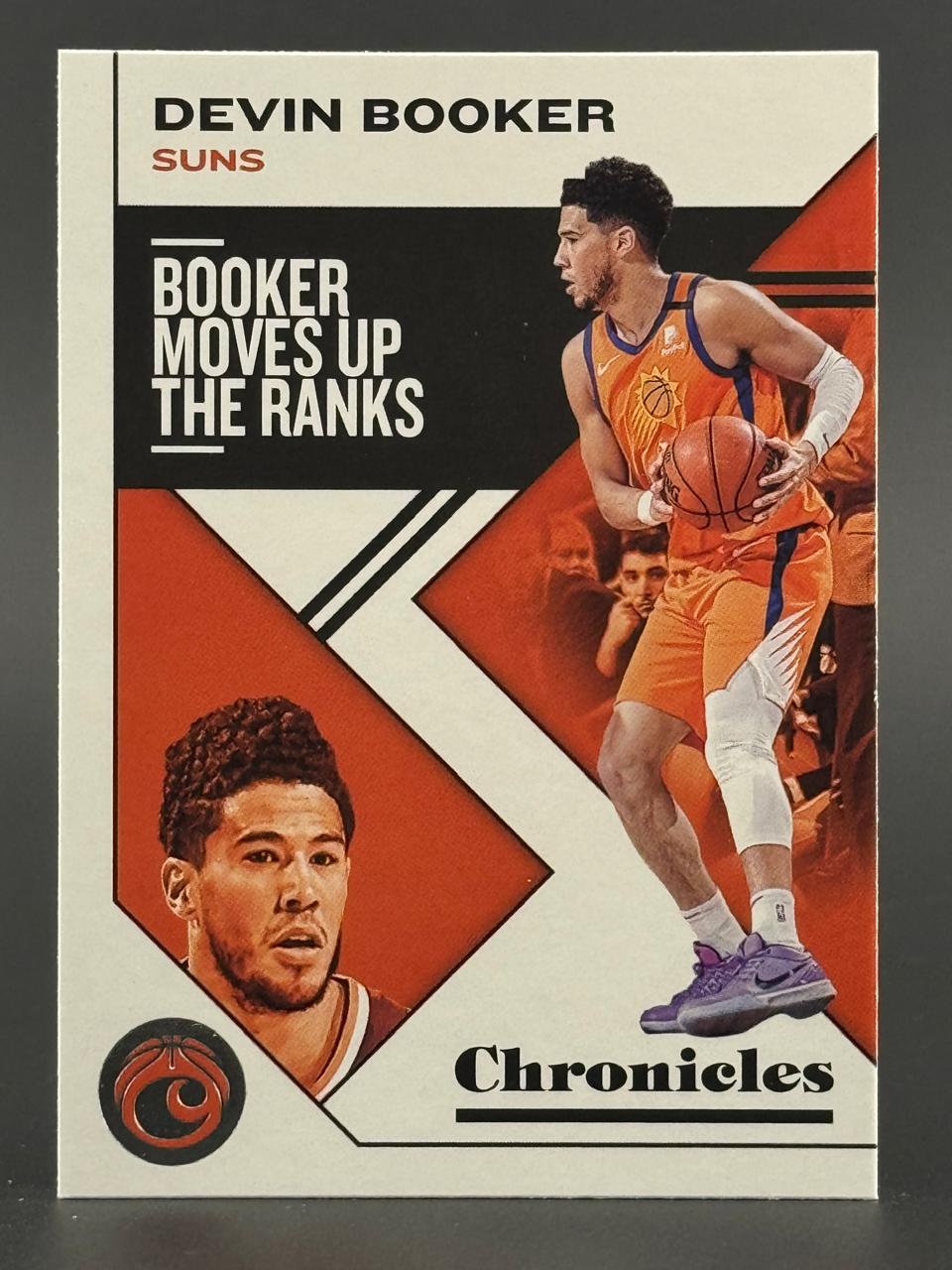 Devin Booker Phoenix Suns 2020-21 Panini Chronicles "Booker Moves Up the Ranks" basketball card.