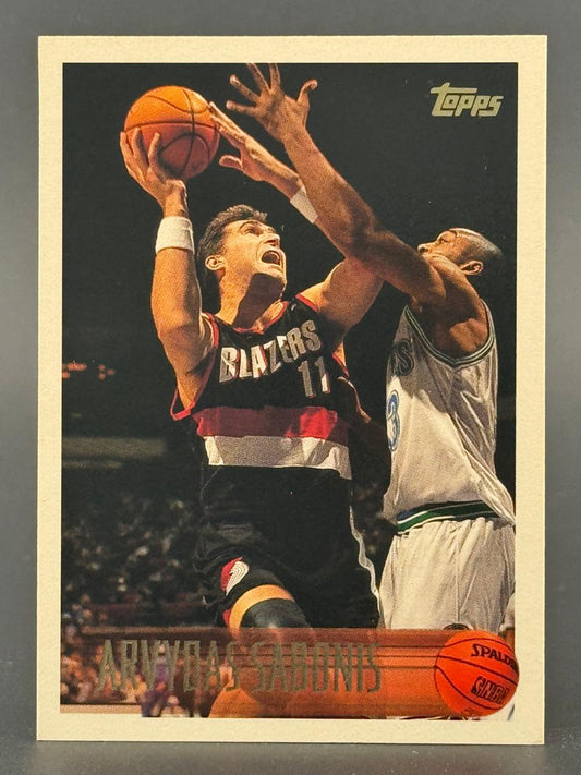 Arvydas Sabonis 1990s Topps basketball card, showing him in a Blazers uniform driving to the basket.