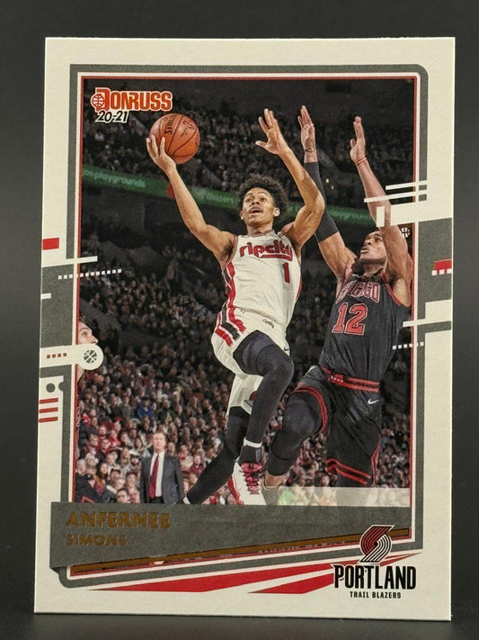 2020-21 Donruss Anfernee Simons trading card showing him driving to the basket in a Portland Trail Blazers jersey.