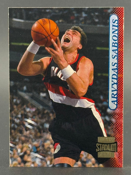 Arvydas Sabonis Topps Stadium Club basketball card, showing him in a Trail Blazers uniform holding a basketball.