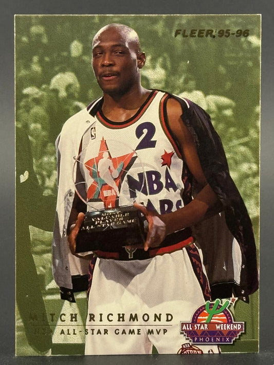 1995-96 Fleer Mitch Richmond trading card showing him holding an All-Star Game MVP trophy.