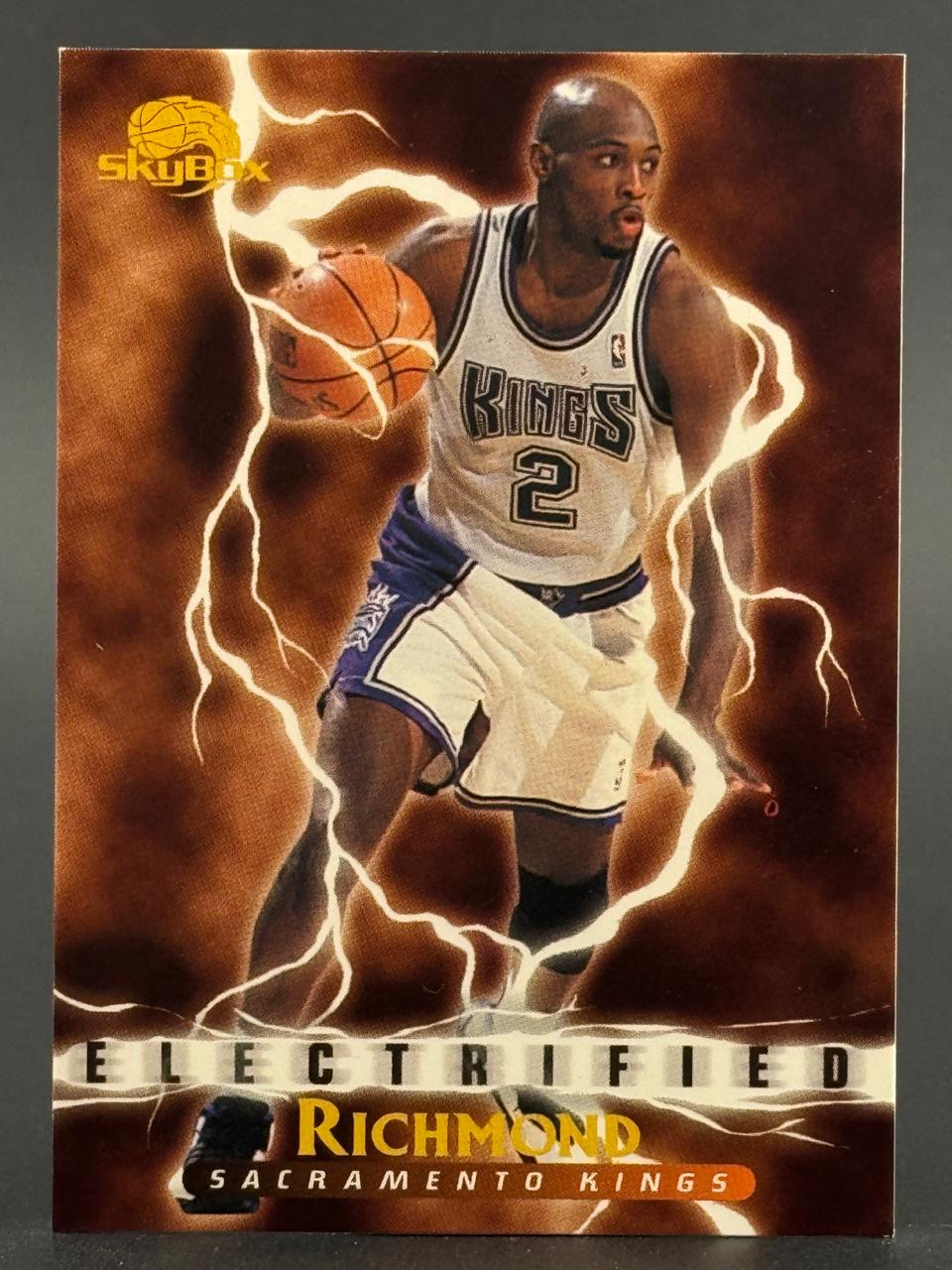 Mitch Richmond Sacramento Kings basketball card, SkyBox Electrified insert, set against a lightning background.