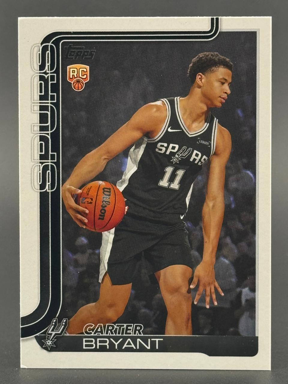 Carter Bryant trading card, San Antonio Spurs, holding a basketball.