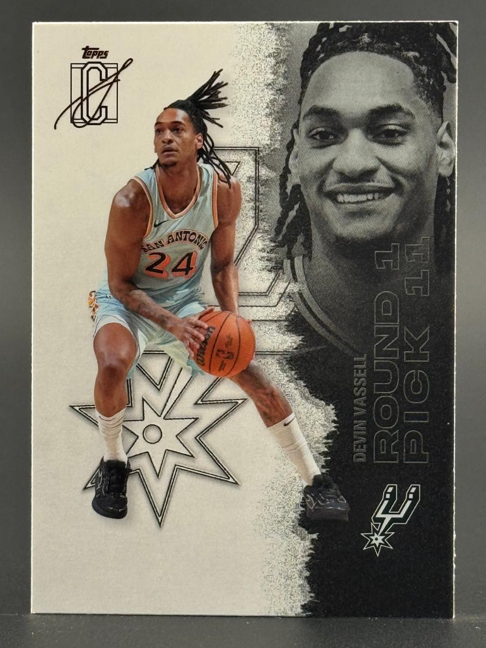 Devin Vassell Topps basketball card featuring him dribbling with a large portrait and "ROUND 1 PICK 11".