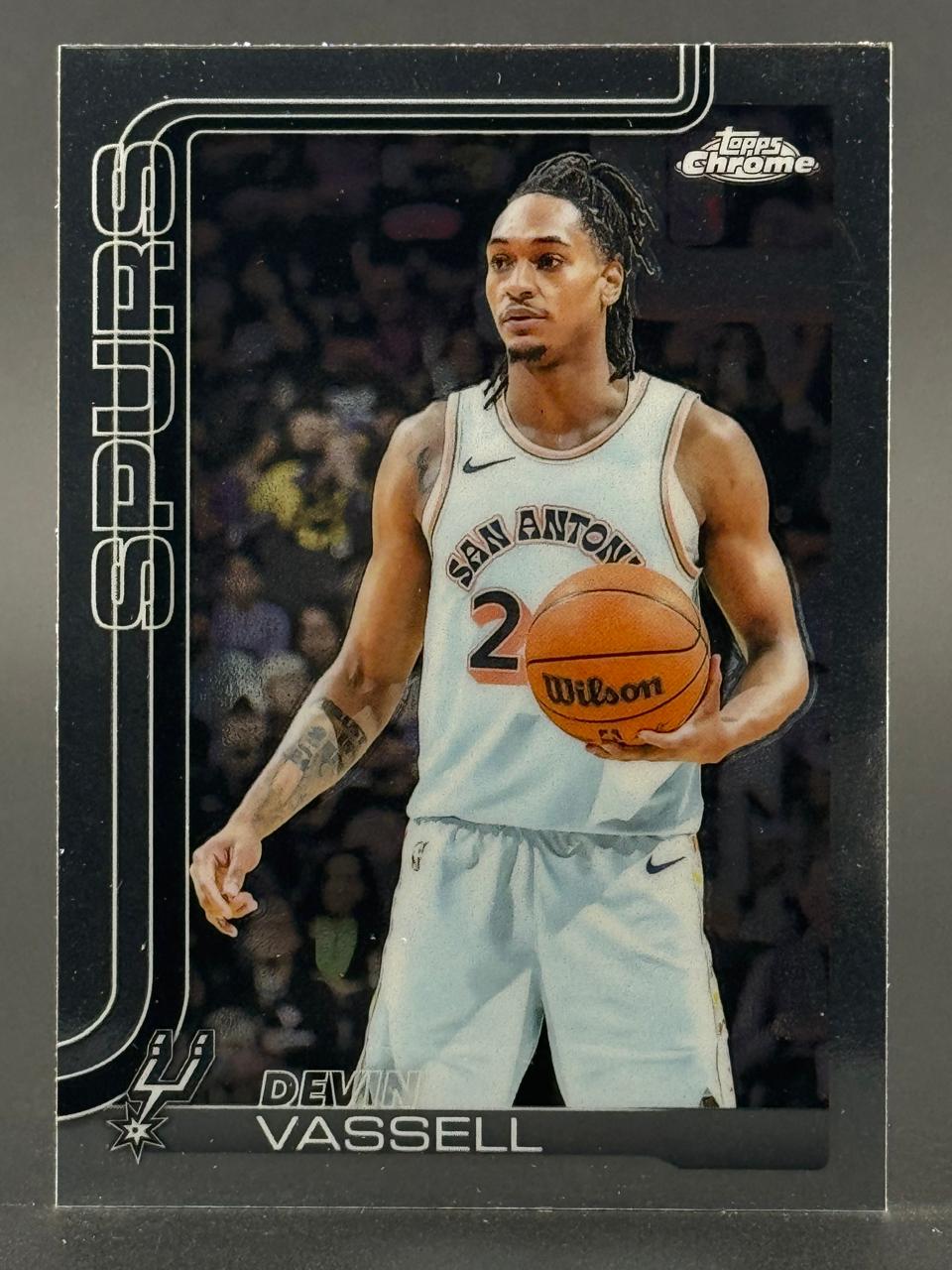 Topps Chrome basketball trading card of Devin Vassell in a San Antonio Spurs uniform holding a basketball.