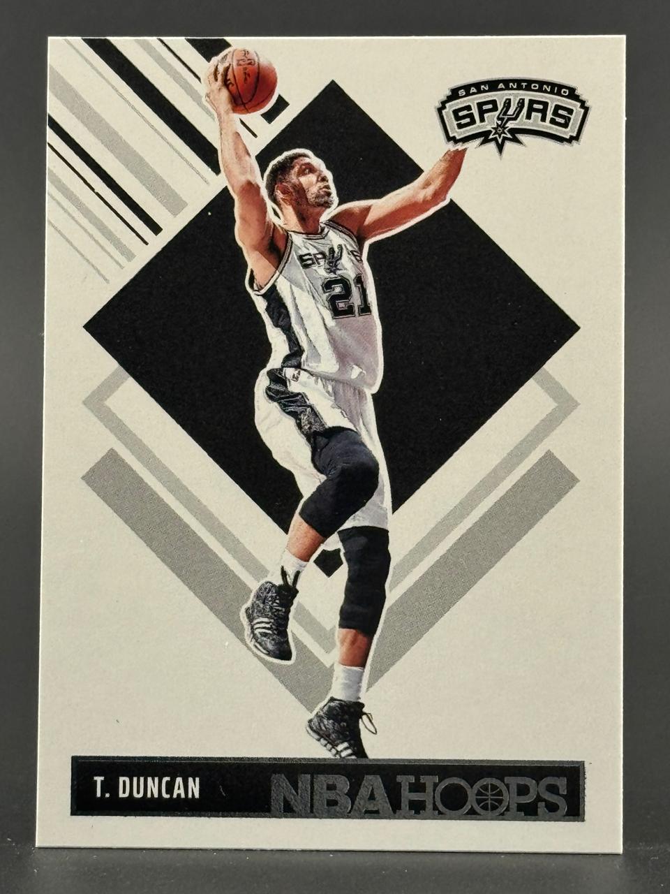 Tim Duncan 21 NBA Hoops basketball card, featuring Duncan in a San Antonio Spurs uniform holding a basketball.